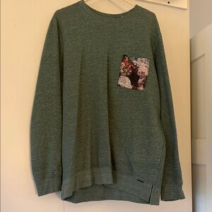 on the byas Men's Heather Green Crewneck with Floral Chest Pocket